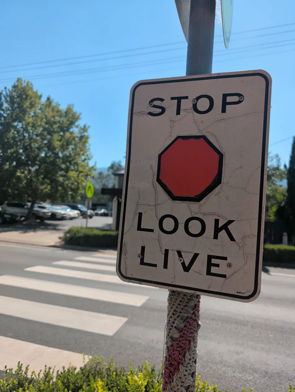 Deteriorating Stop Look Live sign
